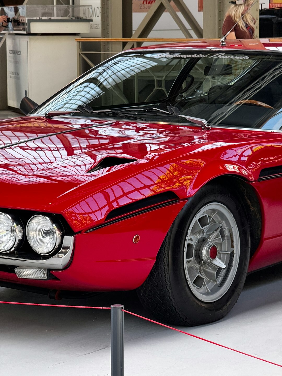 Red Italian classic sports car displayed at a private auction preview