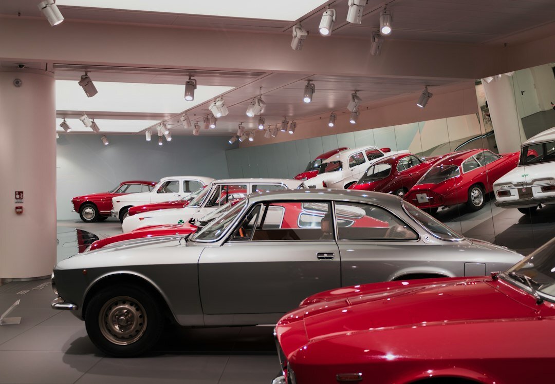 Interior of a classic car museum with rows of vintage automobiles