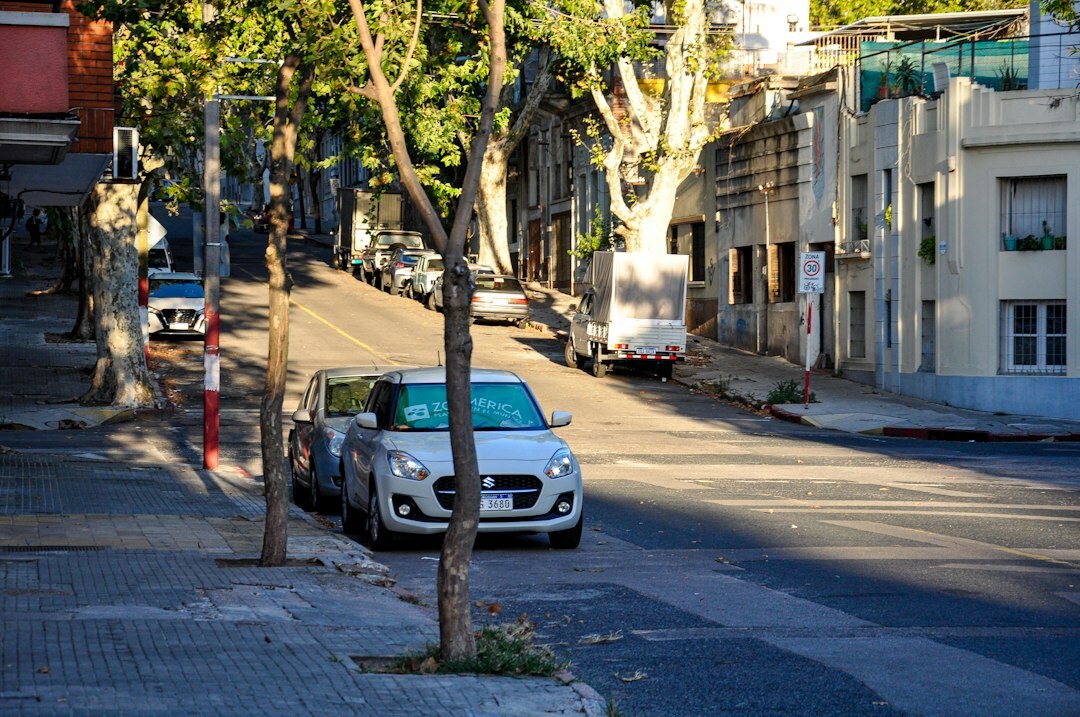 Classic automobile parked along the Rambla of Montevideo at dusk
