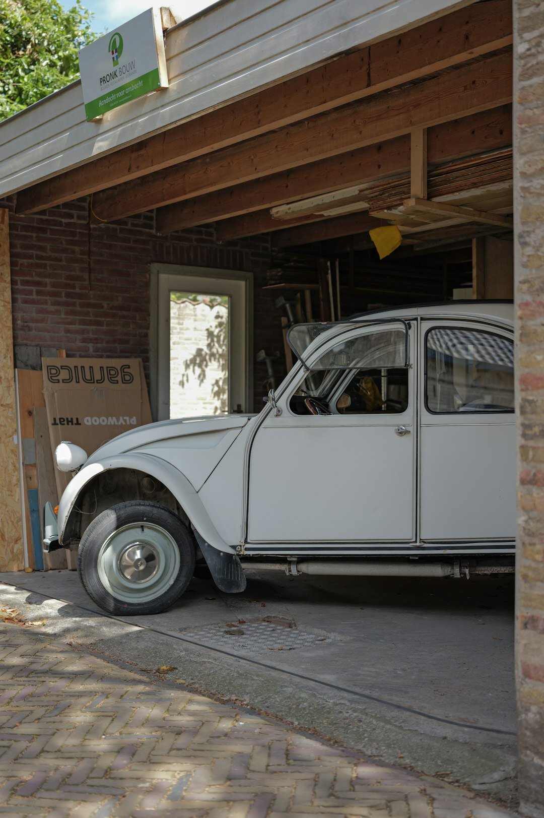 Private collection garage filled with covered and uncovered classic automobiles