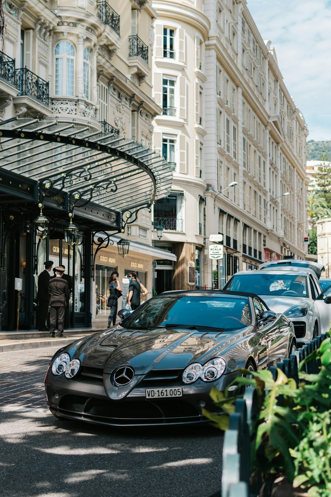 Rare French luxury automobile parked on a summer street in Punta del Este surrounded by onlookers