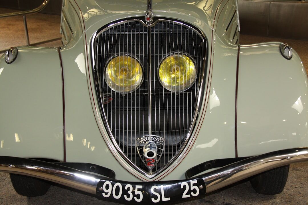 Rare vintage French luxury automobile displayed under dramatic gallery lighting